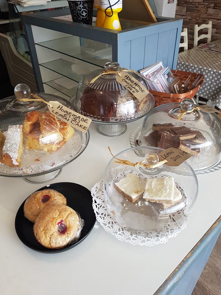 Homemade cakes on the café counter with handwritten cake labels