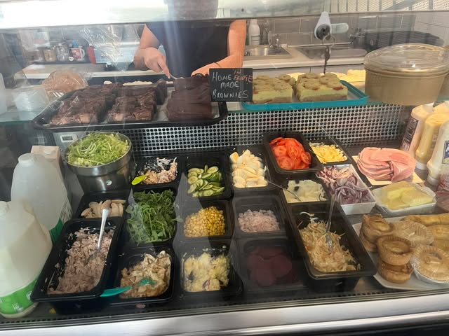 The café sandwich counter with homemade fudge brownies on display